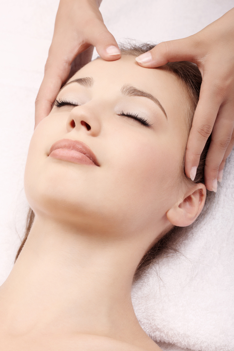 A woman receiving a head massage